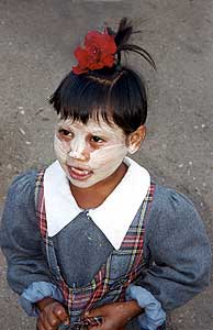 Burmese child with typical tanaka powdered face