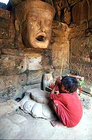 A young cambodian boy is praying
