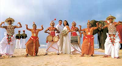 A newly married couple being greeted by the traditional dancers and drummers