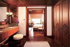 Golden teak timber softened with the  muted tones of luxurious fabrics, characterises the informal spaciousness of the pavilion suites with their waulted ceilings !
