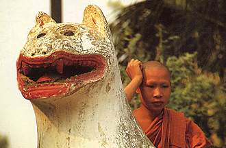 Jung Monk at a temple wall at Luang Prabang